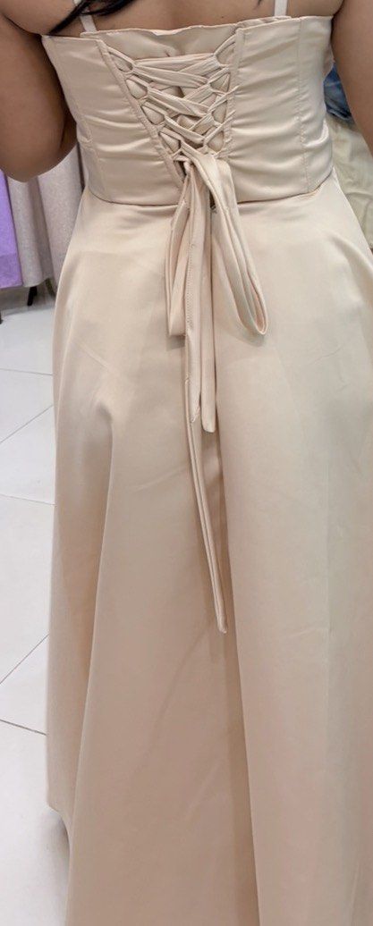 Beige Satin Formal Gown Corset Back (Category: Evening dresses & gowns) located in Quezon City. Submitted by angelajuliet__ (Listing ID 1470776705, Image 2). Description: - SELLING MY GRAD DRESS - Color: Beige - Material: Smooth satin finish - Design: Strapless sweetheart neckline with structured bodice panels - Fit: Adjustable lace-up corset tie at the back for a customizable fit - Skirt: Full, flared floor-length skirt with elegant pleating at 