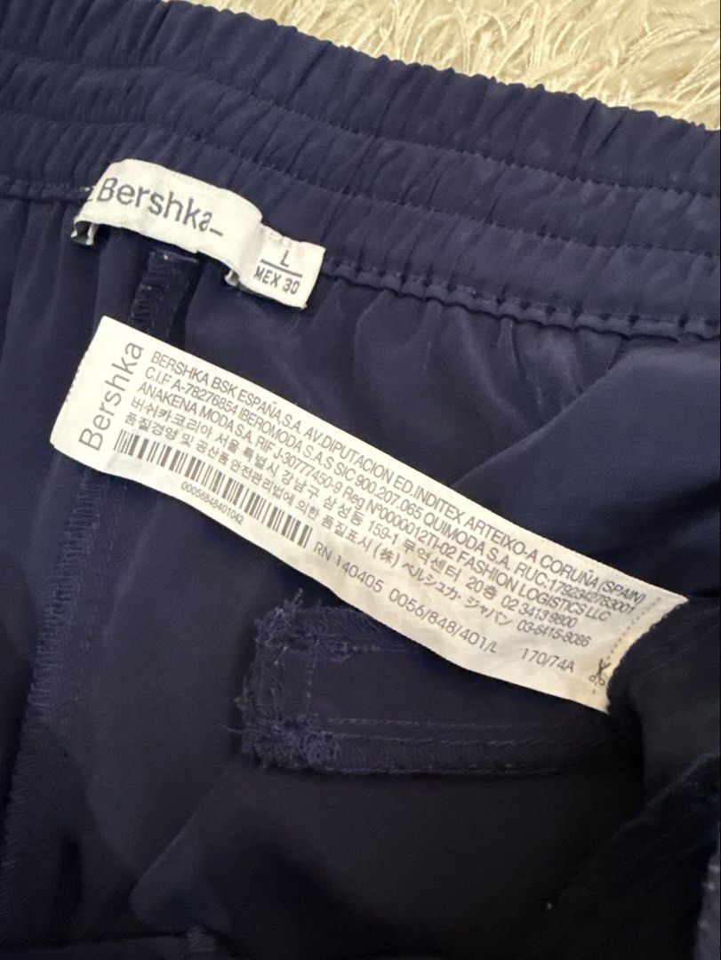 Bershka Navy Blue Jogger Pants Size L (Category: Other Bottoms) located in Quezon City. Submitted by dropdeadprices (Listing ID 1470817513, Image 2). Description: - Brand: Bershka - Item: Jogger pants - Color: Dark navy blue - Size: L (MEX 30) - Features: Elastic waistband with adjustable drawstring, side pockets, faux back pockets, lightweight satin like fabric, and cuffed hems.