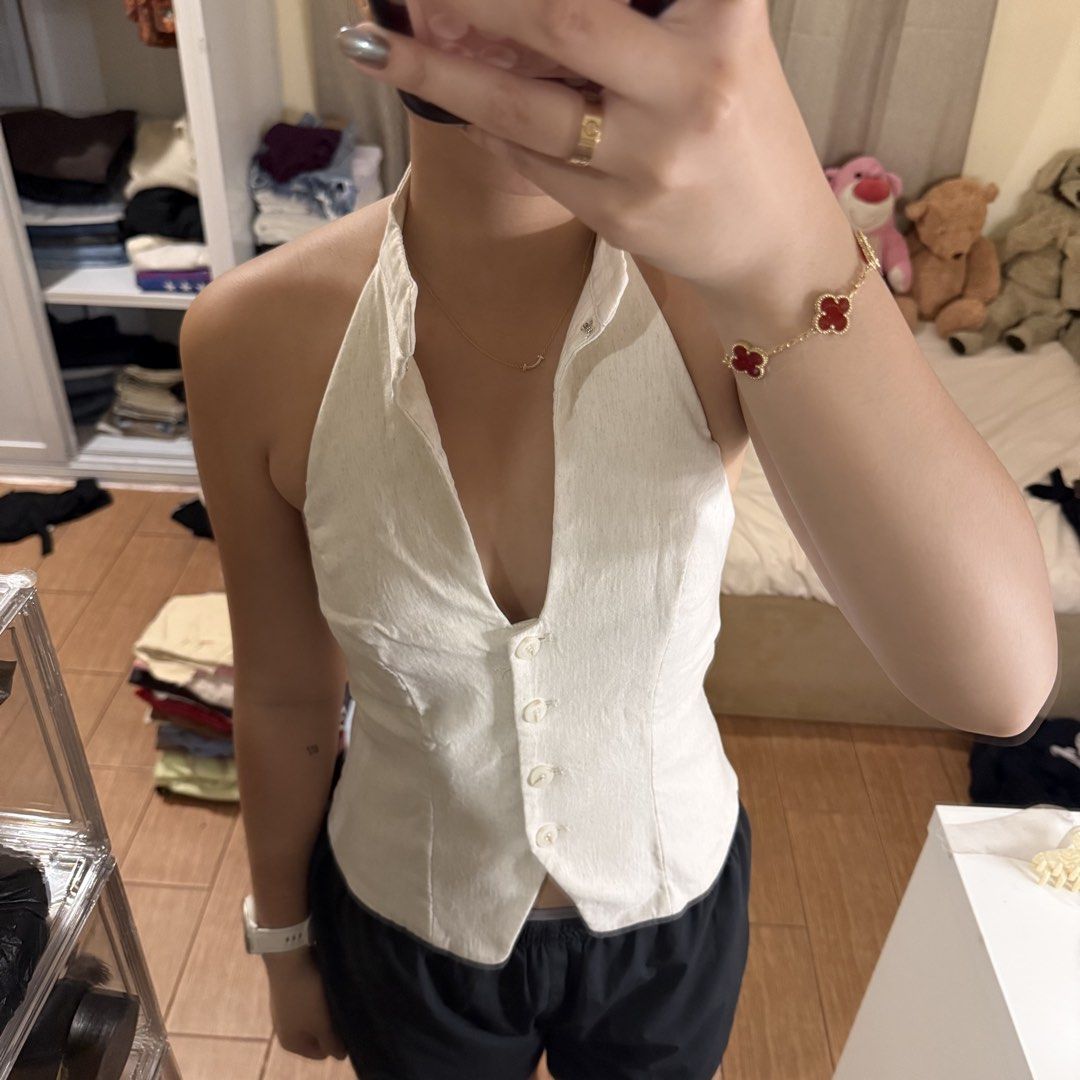Bershka White Halter Top Button Down XS (Category: Sleeveless) located in Quezon City. Submitted by s0l4nge (Listing ID 1470882139, Image 1). Description: - Brand: Bershka - Size: XS - Color: White - Material: Textured linen-like fabric - Design: Halter neck, deep V-neck, front button-down closure, front keyhole cutout, backless with elasticated back hem - Condition: BNWOT.