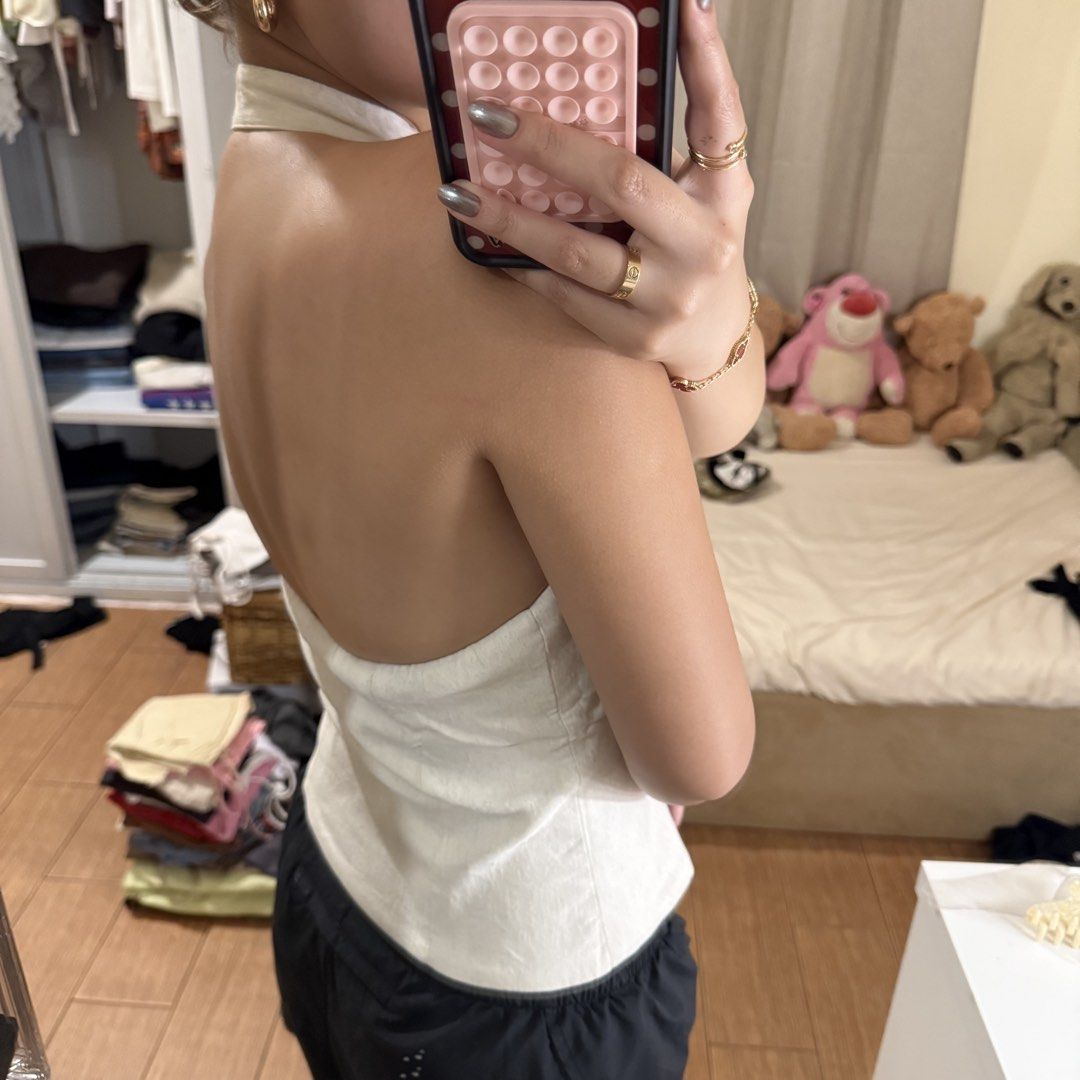 Bershka White Halter Top Button Down XS (Category: Sleeveless) located in Quezon City. Submitted by s0l4nge (Listing ID 1470882139, Image 3). Description: - Brand: Bershka - Size: XS - Color: White - Material: Textured linen-like fabric - Design: Halter neck, deep V-neck, front button-down closure, front keyhole cutout, backless with elasticated back hem - Condition: BNWOT.