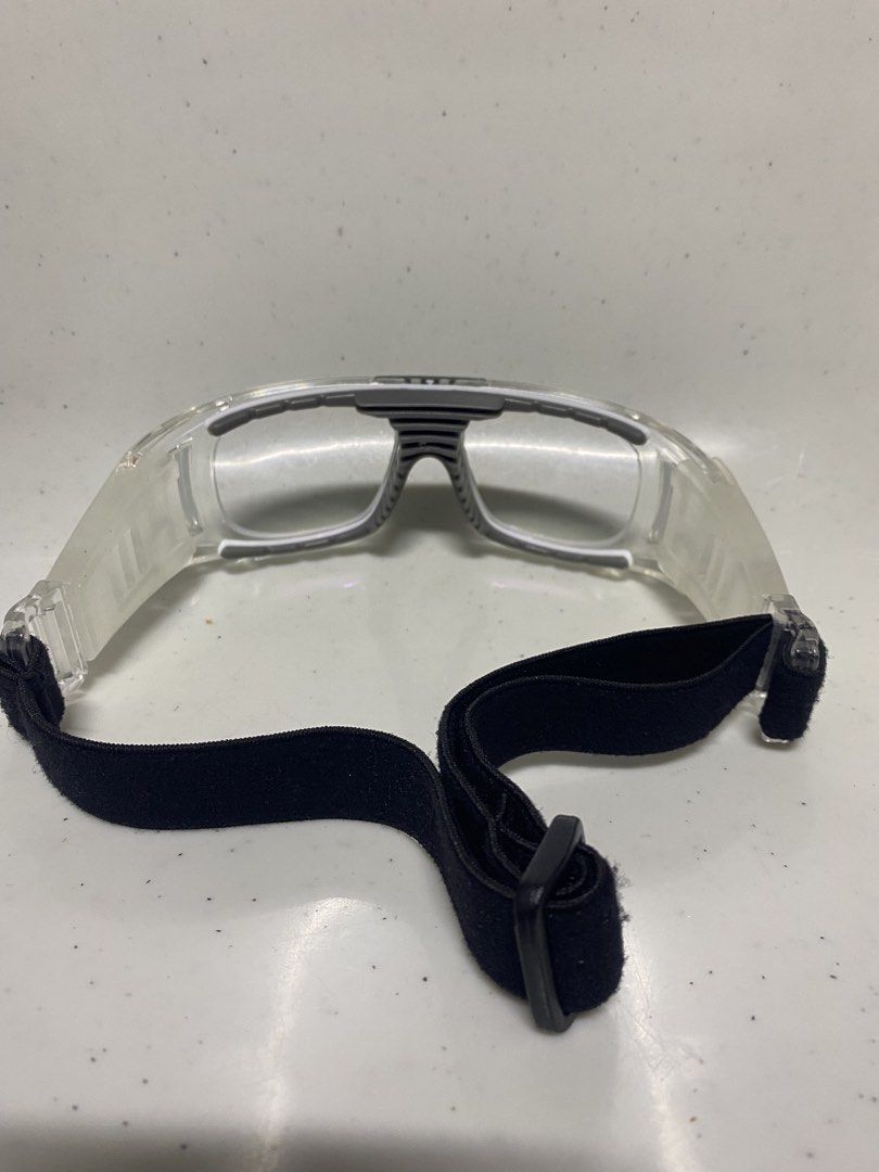 Bertha Sports Protective Goggles with Hard Case (Category: Sunglasses & Eyewear) located in Pasacao. Submitted by wengpullar37205 (Listing ID 1470926948, Image 3). Description: Clear protective sports eyewear by Bertha. Sturdy transparent frame with cushioned inner nose bridge and rubber grip areas on the sides. Adjustable black elastic strap ensures a secure fit during active games. Includes a matching zippered hard shell case with a patterned m