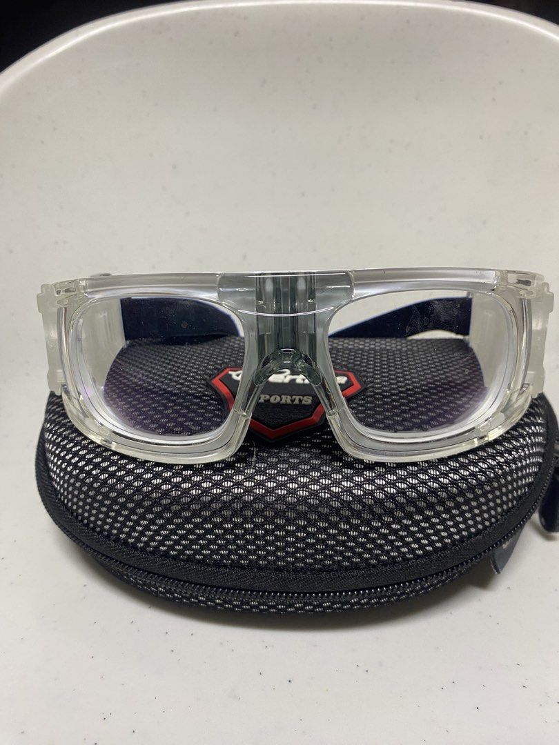 Bertha Sports Protective Goggles with Hard Case (Category: Sunglasses & Eyewear) located in Pasacao. Submitted by wengpullar37205 (Listing ID 1470926948, Image 2). Description: Clear protective sports eyewear by Bertha. Sturdy transparent frame with cushioned inner nose bridge and rubber grip areas on the sides. Adjustable black elastic strap ensures a secure fit during active games. Includes a matching zippered hard shell case with a patterned m