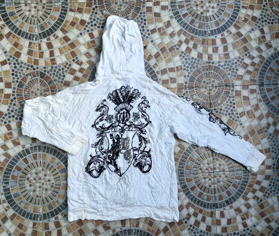 Big Train White Zip Up Hoodie Size M (Category: Coats, Jackets and Outerwear) located in Quezon. Submitted by miksxthrift (Listing ID 1470786650, Image 2). Description: - Brand: Big Train - Color: White with brown waffle-knit hood lining - Size: M (tag attached) - Design: Large graphic print on the back and metallic logo on the chest - Features: Front pockets, ribbed cuffs and hem, drawstrings with metal aglets - Condition: Excellent/Ready to wea