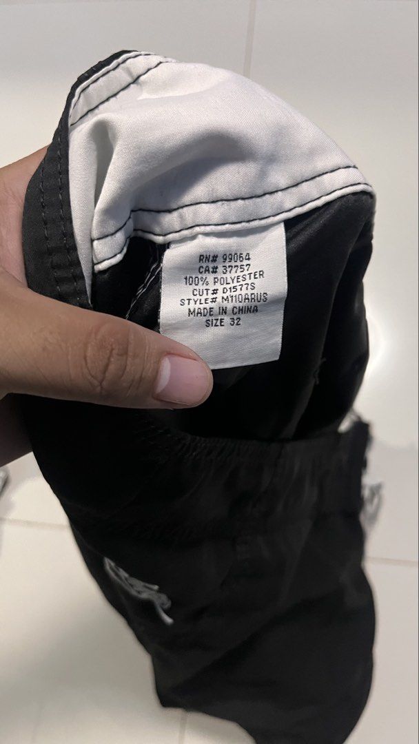 Billabong Black Board Shorts Size 32 (Category: Swim Trunks & Board Shorts) located in Manila. Submitted by wildfire-06ed46 (Listing ID 1470879199, Image 2). Description: - Brand: Billabong - Color: Solid Black - Size: 32 - Material: 100% Polyester - Closure: Drawstring waist - Pockets: Side cargo pocket with buttonhole drain holes - Details: Embroidered brand logos on leg and back waistband - Care: Machine washable.