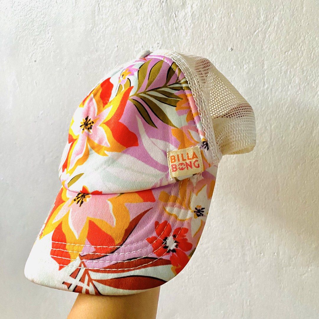 Billabong Floral Trucker Hat (Category: Caps & Hats) located in Caloocan City. Submitted by lovemyclothes21 (Listing ID 1470919767, Image 1). Description: - Brand: Billabong - Design: Colorful tropical floral print on front and brim - Comfort: Breathable white mesh back panels - Fit: Adjustable snapback closure with curved visor - Details: Features signature Billabong woven label and interior branding - Condition: Great fun summer accessory ready