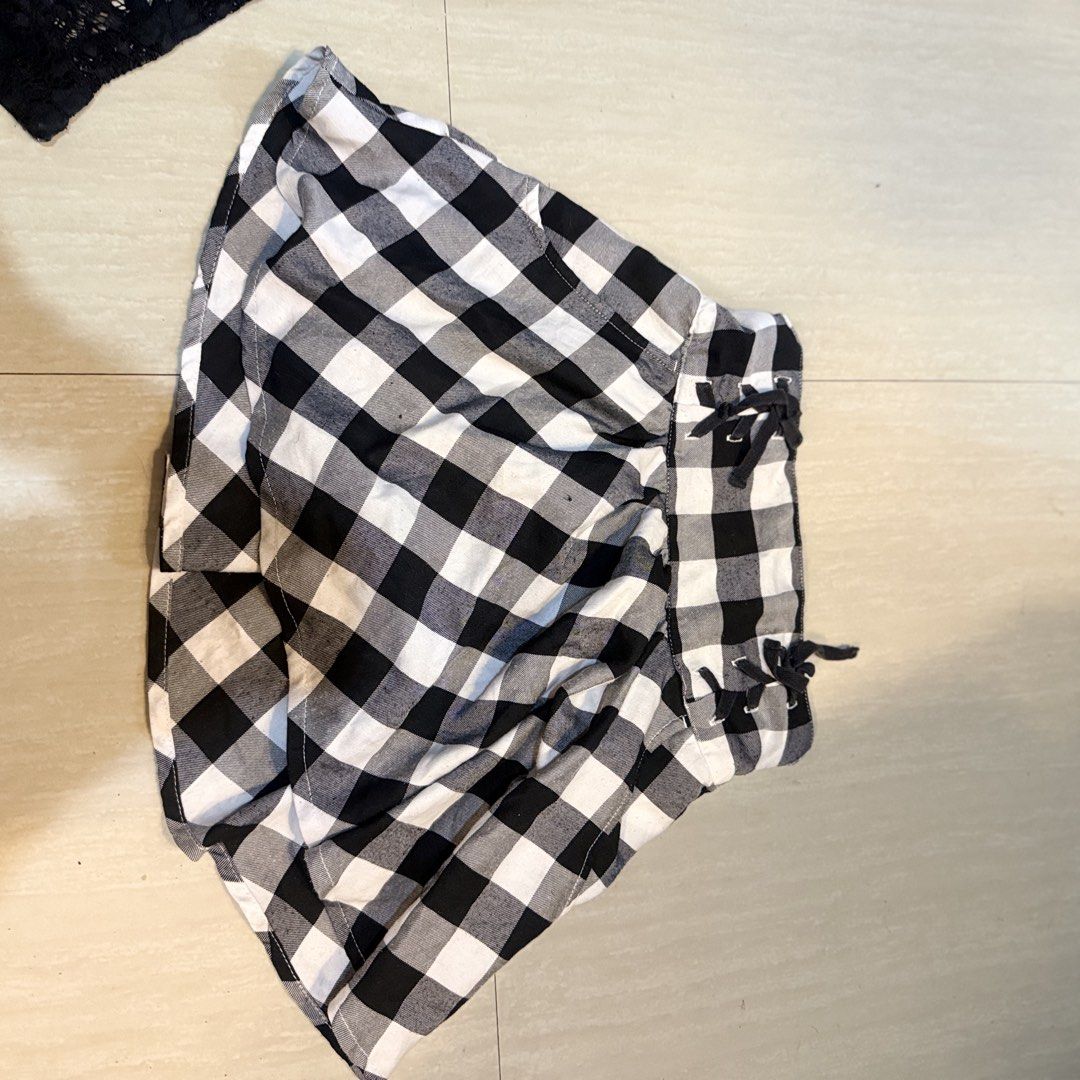 Black and White Gingham Plaid Mini Skirt (Category: Skirts) located in Zamboanga. Submitted by kittyluvs (Listing ID 1470928233, Image 1). Description: - Style: Flare skater skirt with pleated look - Pattern: Classic black and white gingham plaid - Details: Cute lace-up tie details on the sides of the waistband - Length & Fabric: Short length and lightweight material - Versatility: Perfect for casual everyday wear or dressing up for a night out, 
