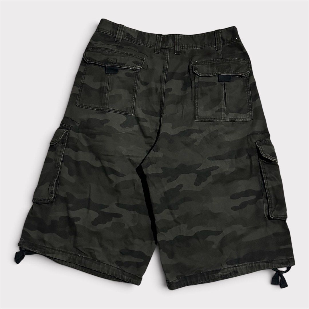 Black Camo Cargo Shorts with Drawstring Hems (Category: Shorts) located in Manila. Submitted by jeproxthrift (Listing ID 1470922829, Image 1). Description: - Dark grey and black camouflage design - Multiple side and back pockets for ample storage - Adjustable drawstring cords at the leg openings - Built-in belt loops around the waistline - Durable, heavy canvas-like material - Great for everyday wear and street style.