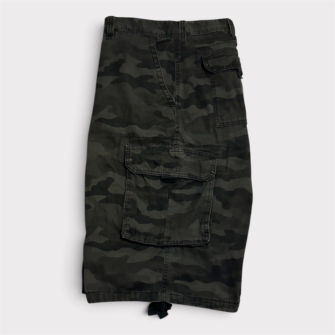 Black Camo Cargo Shorts with Drawstring Hems (Category: Shorts) located in Manila. Submitted by jeproxthrift (Listing ID 1470922829, Image 2). Description: - Dark grey and black camouflage design - Multiple side and back pockets for ample storage - Adjustable drawstring cords at the leg openings - Built-in belt loops around the waistline - Durable, heavy canvas-like material - Great for everyday wear and street style.