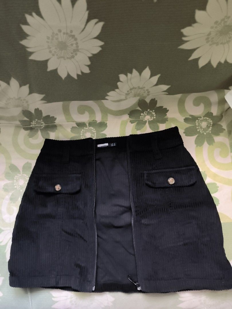 Black Corduroy Zip Front Mini Skirt Size S (Category: Skirts) located in Bulacan. Submitted by jvblaguard08460 (Listing ID 1470753518, Image 2). Description: - Style: Black corduroy mini skirt with front zipper closure - Features: Two functional button-flap pockets and waist belt loops - Fabric: Textured velvet rib fabric - Size: S (EUR S, USA S, MEX 26) - Origin: Made in Cambodia - Condition: Excellent, ready to wear.