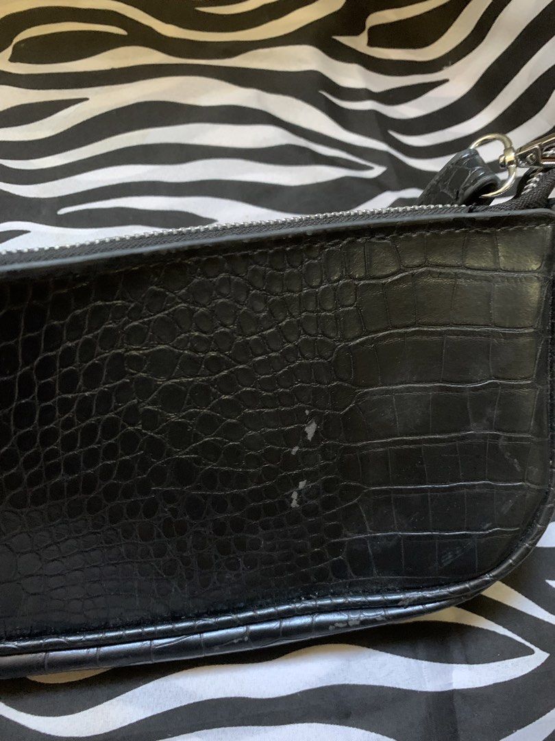 Black Crocodile Embossed Shoulder Bag (Category: Shoulder Bags) located in Manila. Submitted by usagichan_rabbit (Listing ID 1470746265, Image 3). Description: - Color & Texture: Stylish black with a faux crocodile skin finish - Hardware: Sleek silver-tone hardware with a secure zip top closure - Versatility: Compact design easily transitions from casual daywear to evening outfits - Condition: Noticeable wear and scuffs on the bottom corners and 