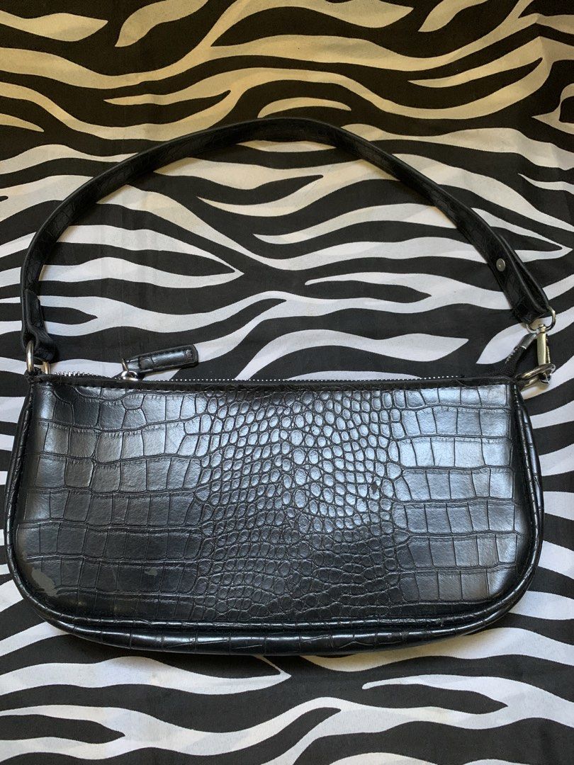 Black Crocodile Embossed Shoulder Bag (Category: Shoulder Bags) located in Manila. Submitted by usagichan_rabbit (Listing ID 1470746265, Image 1). Description: - Color & Texture: Stylish black with a faux crocodile skin finish - Hardware: Sleek silver-tone hardware with a secure zip top closure - Versatility: Compact design easily transitions from casual daywear to evening outfits - Condition: Noticeable wear and scuffs on the bottom corners and 