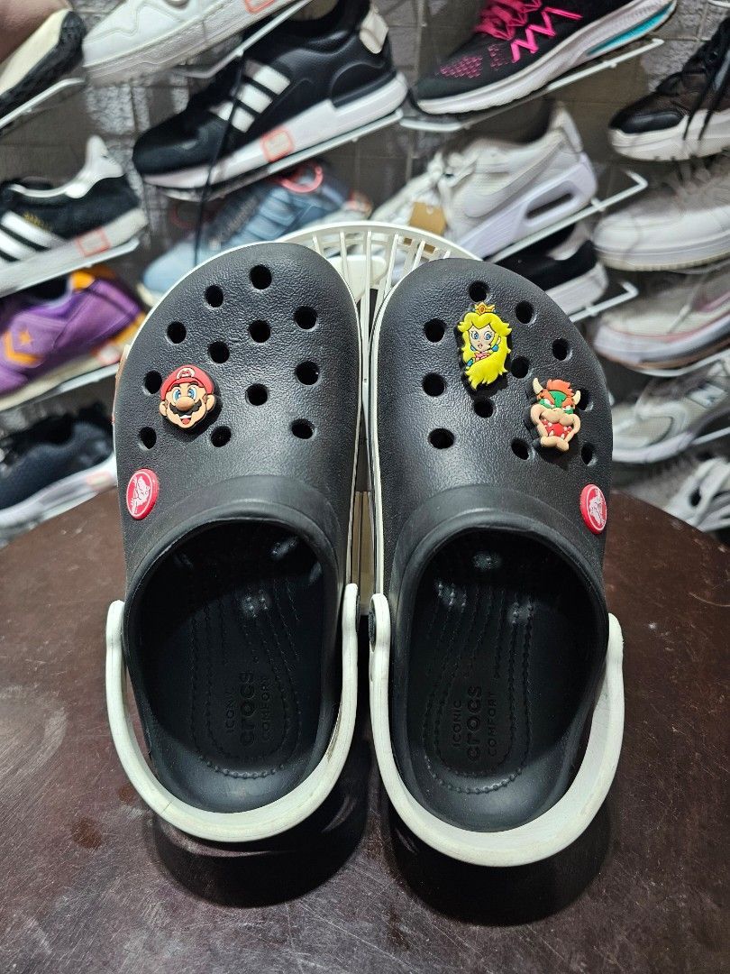 Black Crocs Crocband clogs FREE SHIPPING!!! (Category: Babies & Kids Fashion) located in Baguio. Submitted by kayeonlineshop (Listing ID 1470768178, Image 1). Description: • Model Style: This is the Crocs Crocband Clog, identifiable by the smooth upper texture and the distinct sporty white stripe wrap running along the midsole band. • Personalized Charms: The left shoe is decorated with a couple of custom Jibbitz™ shoe charms, including a promine