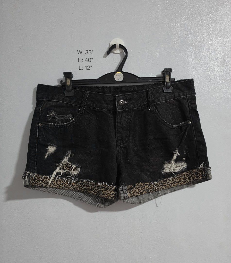 Black Denim Shorts with Leopard Print Cuffs and Studs (Category: Shorts) located in Paranaque City. Submitted by franinnashop (Listing ID 1470848796, Image 1). Description: Declutter - Style: Edgy black denim shorts with mid-rise fit - Details: Distressed throughout with studded front and back pockets - Accent: Rolled cuffs lined with chic leopard print fabric - Closure: Classic button and zip fly - Measurements: 33 inches width, 12 inches length