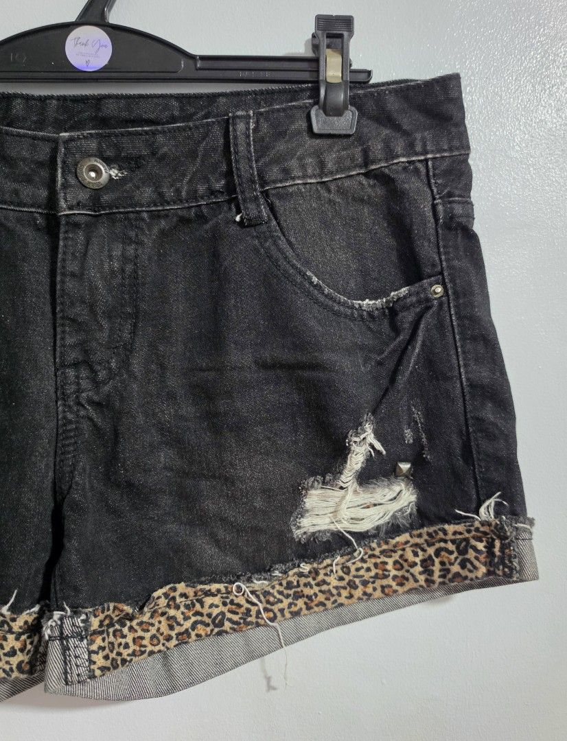 Black Denim Shorts with Leopard Print Cuffs and Studs (Category: Shorts) located in Paranaque City. Submitted by franinnashop (Listing ID 1470848796, Image 2). Description: Declutter - Style: Edgy black denim shorts with mid-rise fit - Details: Distressed throughout with studded front and back pockets - Accent: Rolled cuffs lined with chic leopard print fabric - Closure: Classic button and zip fly - Measurements: 33 inches width, 12 inches length