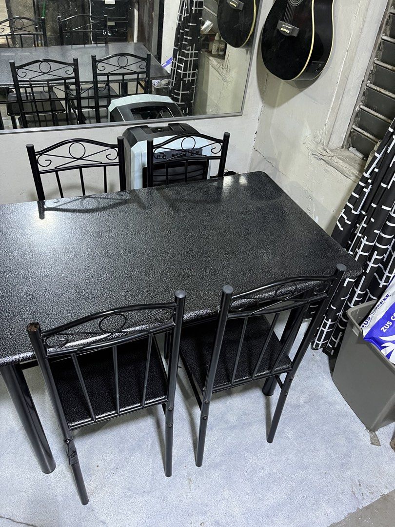 Black Dining Table with Four Matching Chairs (Category: Tables & Sets) located in Manila. Submitted by jettypatootie_12345 (Listing ID 1470845212, Image 1). Description: - Complete dining set: 1 black textured table and 4 matching metal chairs - Space-saving design: Chairs tuck neatly underneath the table - Durable build: Sturdy solid metal frames throughout - Stylish finish: Sleek speckled surface finish - Perfect size: Ideal for small dining sp