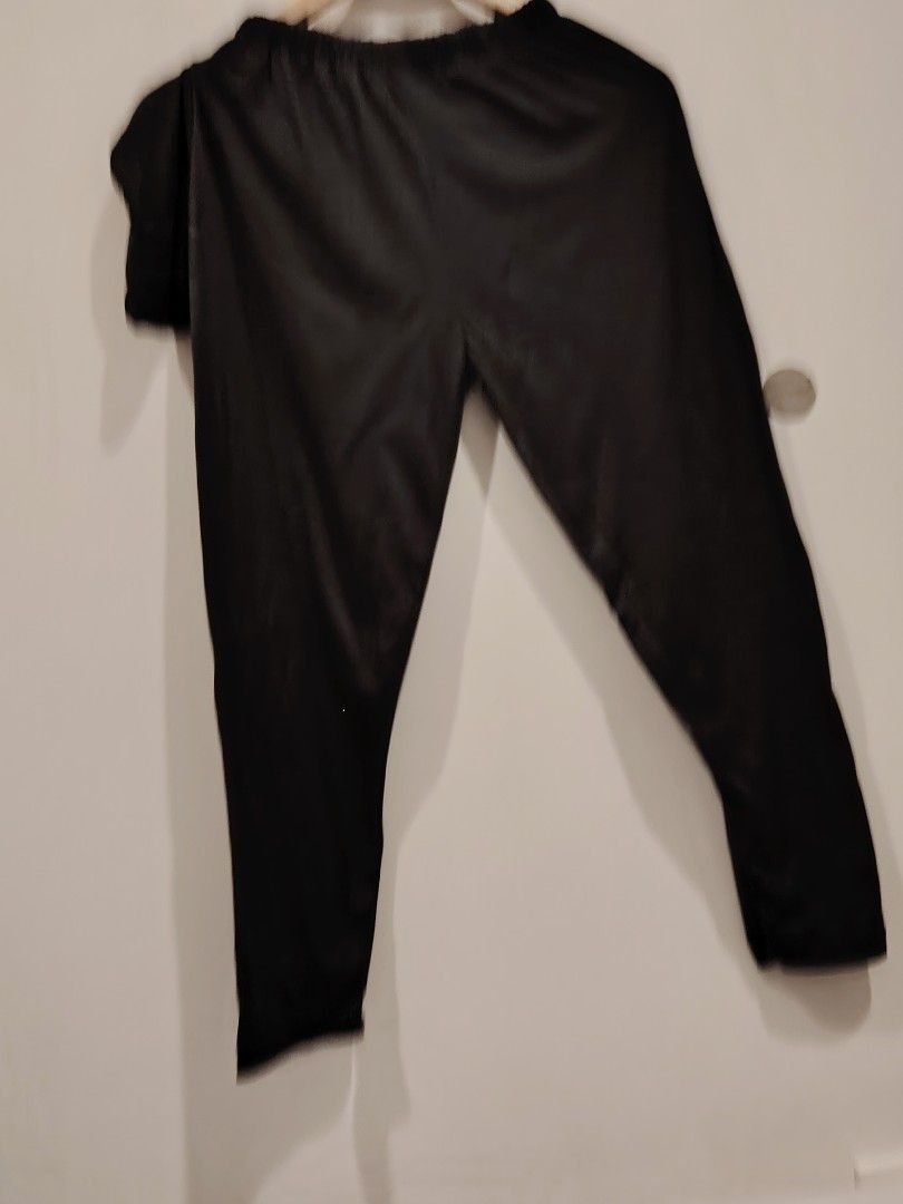 Black elastic waist pants trousers (Category: Trousers) located in Manila. Submitted by jacelllamb12233 (Listing ID 1470860283, Image 3). Description: - Color: Classic Black - Material: Shiny, smooth, and stretchy fabric - Waistband: Comfortable elastic waistband for easy slip-on style - Fit: Full-length legs with a flexible fit - Condition: Clean and well-maintained overall - Perfect for effortless everyday wear.