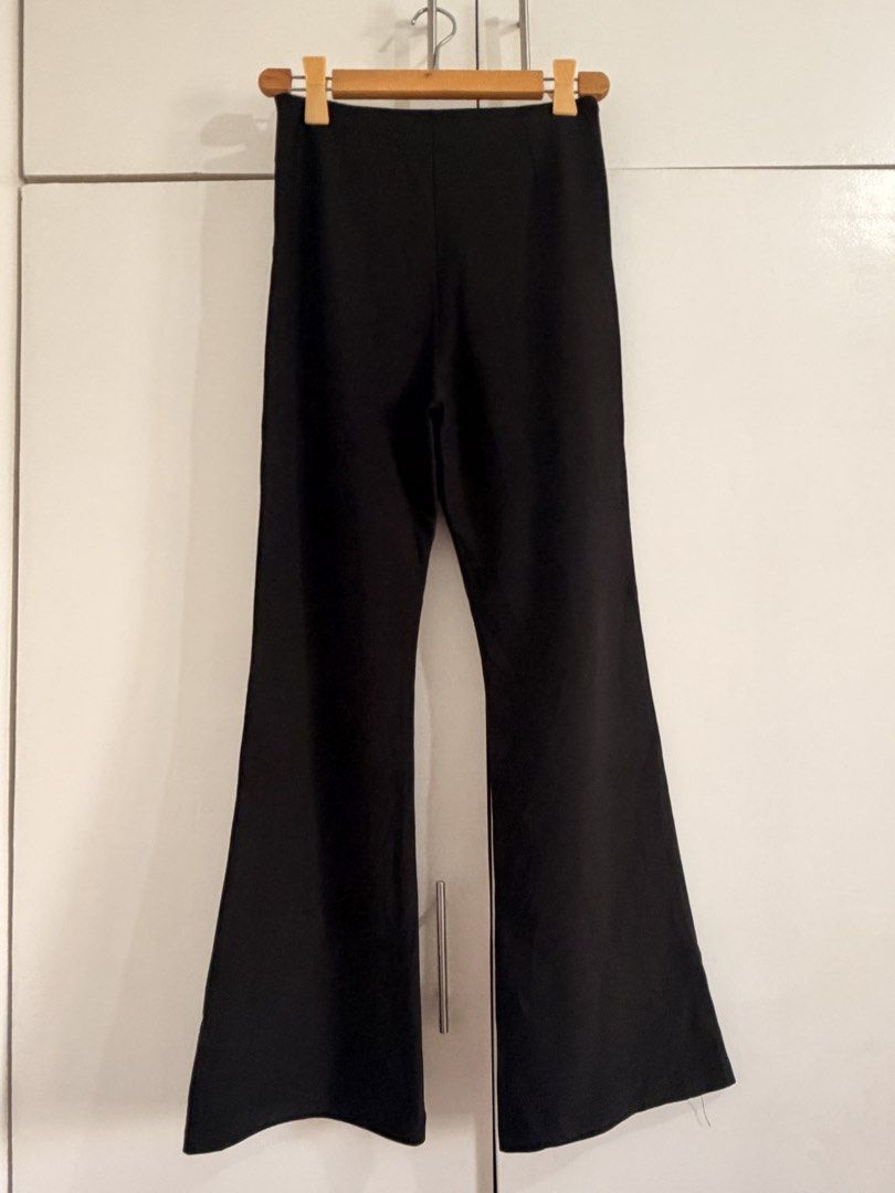 Black flare pants with side zip and drawstring waist (Category: Jeans) located in Marikina City. Submitted by _bananahanaa (Listing ID 1470801620, Image 2). Description: - Color: Solid black - Fit: High-waisted with flared legs from the knee down - Closure: Convenient side zipper - Detail: Subtle front drawstring - Fabric: Smooth and comfortable - Styling: Perfect for both casual and dressy occasions size 27-28.