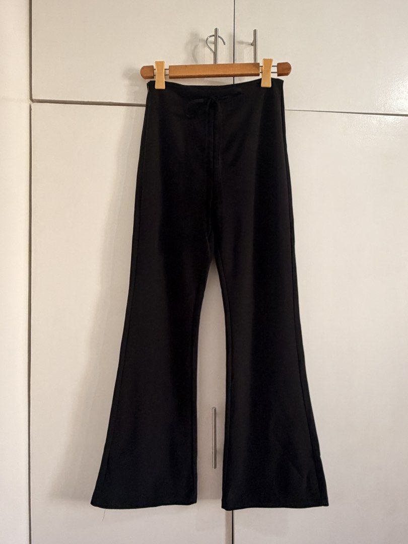 Black flare pants with side zip and drawstring waist (Category: Jeans) located in Marikina City. Submitted by _bananahanaa (Listing ID 1470801620, Image 1). Description: - Color: Solid black - Fit: High-waisted with flared legs from the knee down - Closure: Convenient side zipper - Detail: Subtle front drawstring - Fabric: Smooth and comfortable - Styling: Perfect for both casual and dressy occasions size 27-28.