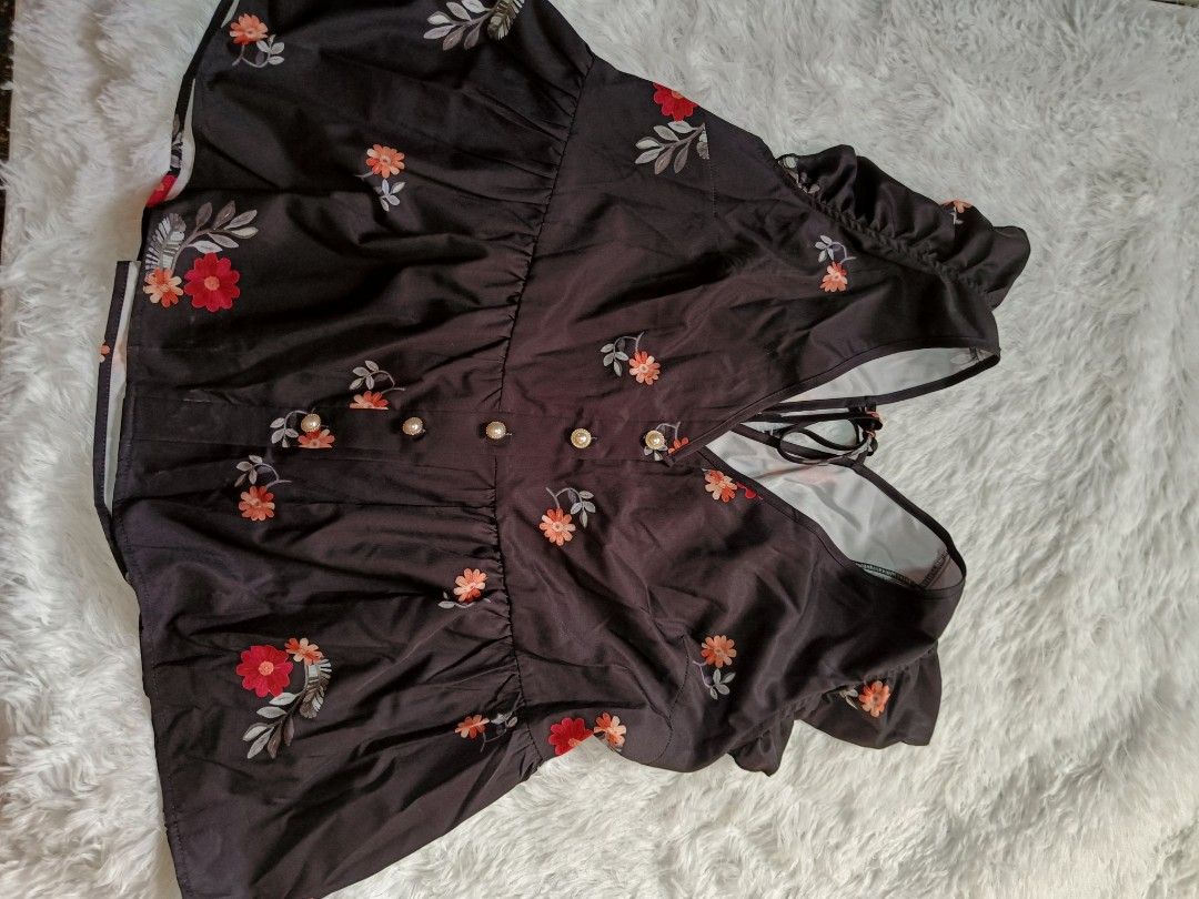 Black floral top with pearl buttons (Category: Bikinis & Swimsuits) located in Orani. Submitted by mbfb_btn (Listing ID 1470824914, Image 1). Description: -Brandnew Style: Cute one-piece swimsuit - Color/Pattern: Black base with vibrant orange and red floral print all over - Neckline: Flattering V-neck with decorative pearl-accented buttons on the front - Straps: Adjustable straps that tie securely in the back - Condition: Brand new, perfect for 