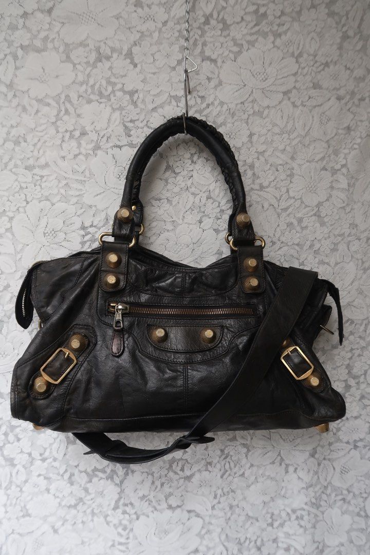 Black Leather Handbag with Gold Hardware and Studs (Category: Luxury Bags & Wallets) located in Baguio. Submitted by dutefinds (Listing ID 1470784771, Image 1). Description: Signs of use and bent piping of top handle, still nice and wearable - NO TAGS L- 16” W-6.5” H- 8.5”.