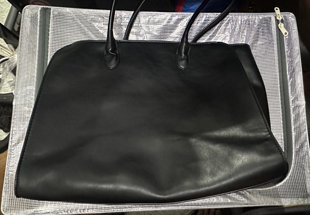 Black leather tote bag with shoulder straps (Category: Tote Bags) located in Pasig City. Submitted by thingsimselling_jdl (Listing ID 1470780758, Image 1). Description: - Color: Black - Material: Smooth faux leather - Design: Minimalist structured look with clean edge stitching - Features: Roomy main compartment with double shoulder straps - Capacity: Easily fits laptops, folders, and daily essentials - Best for: Everyday use, work, or school.