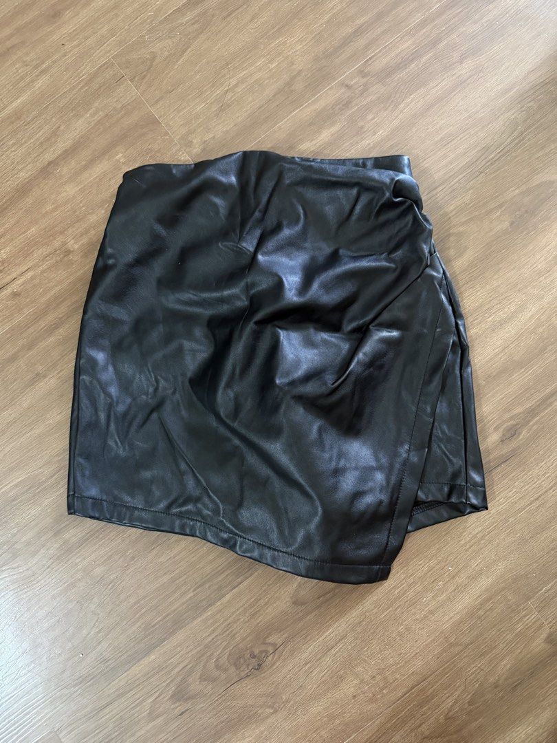 Black leather wrap mini skort (Category: Skirts) located in Manila. Submitted by yncldo (Listing ID 1470759361, Image 1). Description: - Color: Black - Fit: High waist - Design: Wrap style front with an asymmetrical hem - Garterized.