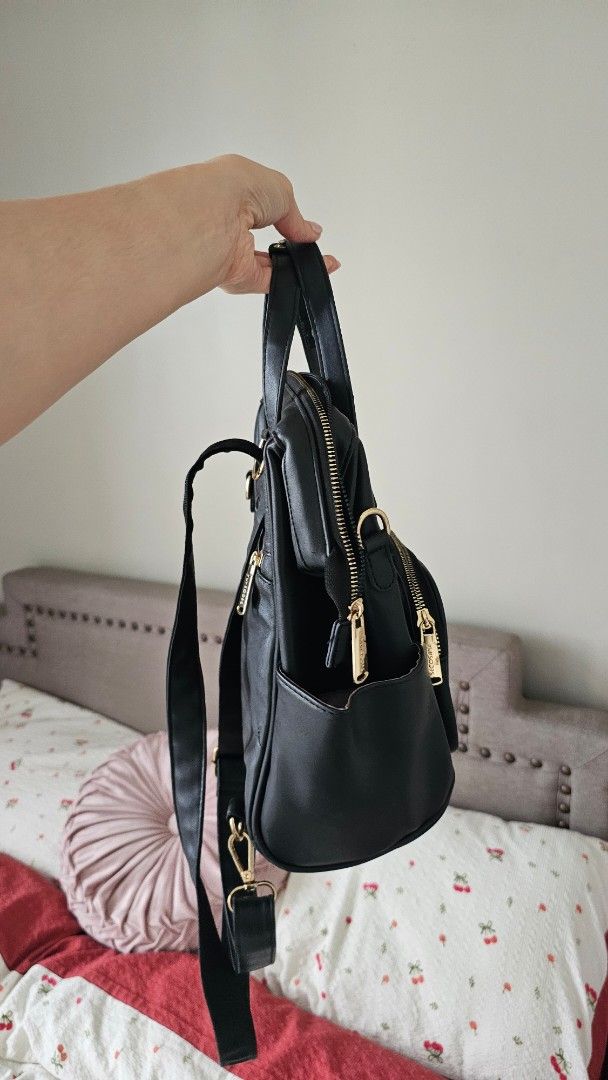 Black Quilted Faux Leather Convertible Backpack (Category: Backpacks) located in Quezon City. Submitted by cluttercat_ (Listing ID 1470784624, Image 3). Description: Secosana backpack for sale - Color & Material: Black faux leather with stylish gold hardware - Exterior: Front quilted pocket, vertical zip compartment, and top grab handles - Interior: Fabric-lined with slip pockets and one secure zippered pocket - Closure: Wide-opening structured f