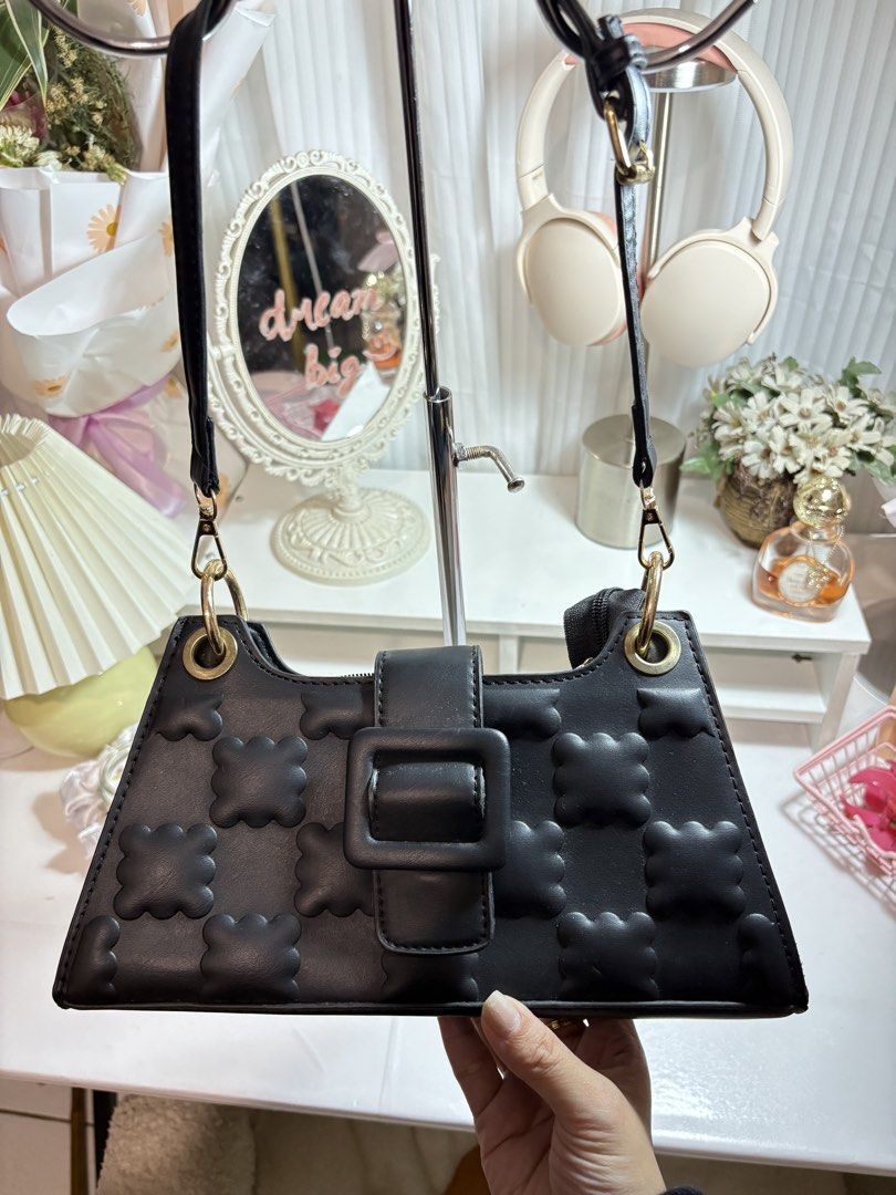 Black Quilted Shoulder Bag with Buckle (Category: Shoulder Bags) located in Santo Tomas. Submitted by skyy14 (Listing ID 1470864010, Image 3). Description: - Color: Classic Black - Design: Textured quilt pattern with stylish decorative buckle flap - Closure: Dual security with magnetic snap and top zipper entry - Strap: Adjustable shoulder strap accented with gold-tone hardware rings - Interior: Clean lining featuring a convenient zipper pocket f
