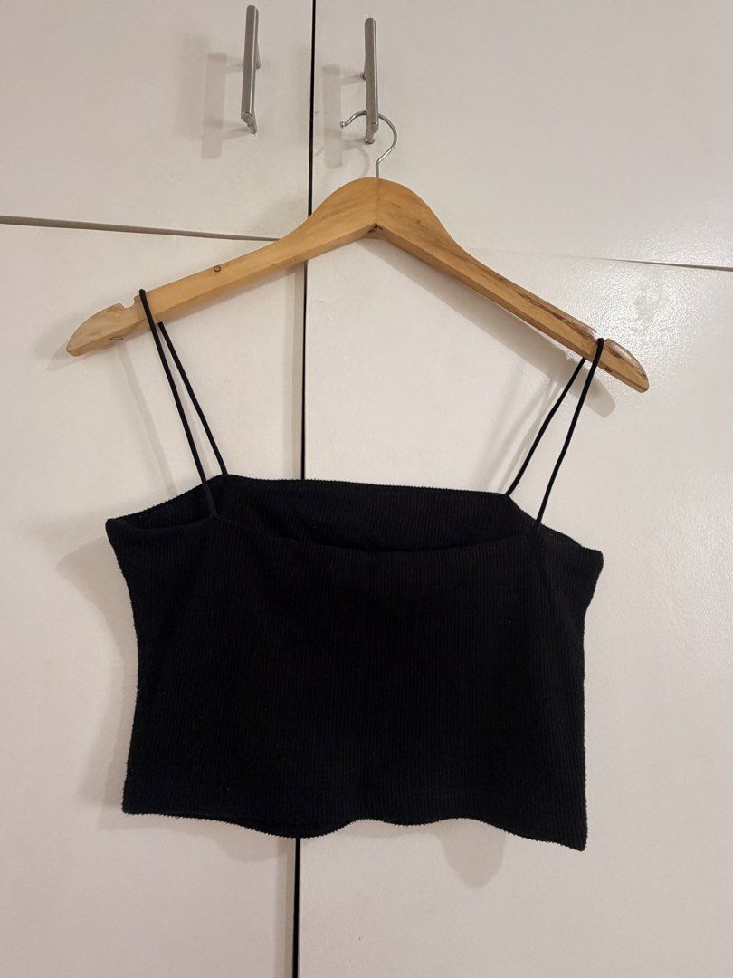 Black Ribbed Spaghetti Strap Crop Top (Category: Sleeveless) located in Marikina City. Submitted by _bananahanaa (Listing ID 1470800542, Image 2). Description: - Color: Black - Style: Cropped cami top with thin spaghetti straps and straight neckline - Fabric: Textured ribbed knit with great stretch - Fit: Fitted style that flatters the figure - Versatility: Essential basic piece, perfect to match with high-waisted jeans or skirts for casual wear 