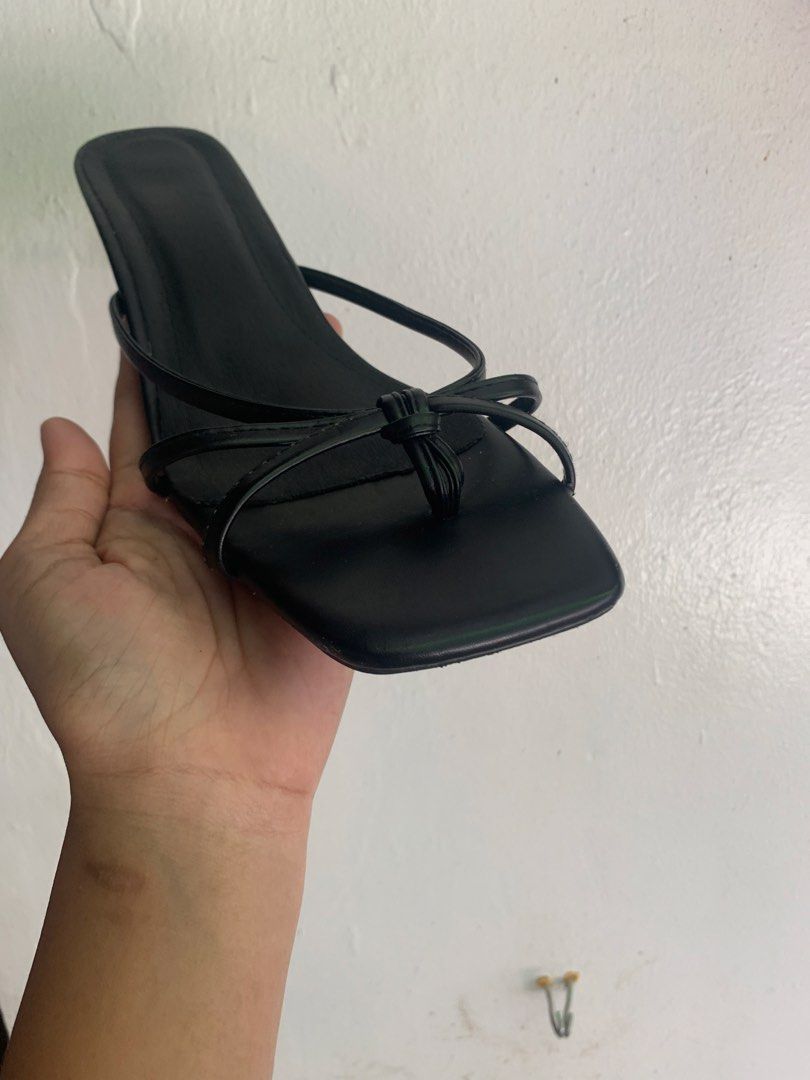 Black Strappy Kitten Heels Square Toe (Category: Heels) located in Manila. Submitted by mixwearclosetclothingstore (Listing ID 1470762579, Image 3). Description: - Style: Black strappy heels with a modern square toe and elegant thin kitten heels - Detail: Delicate knotted straps across the top for a stylish look - Inclusions: Comes with the original teal ONEW shoe box - Condition: Brand new, sole shows only minor dust from handling - Sizing: Size