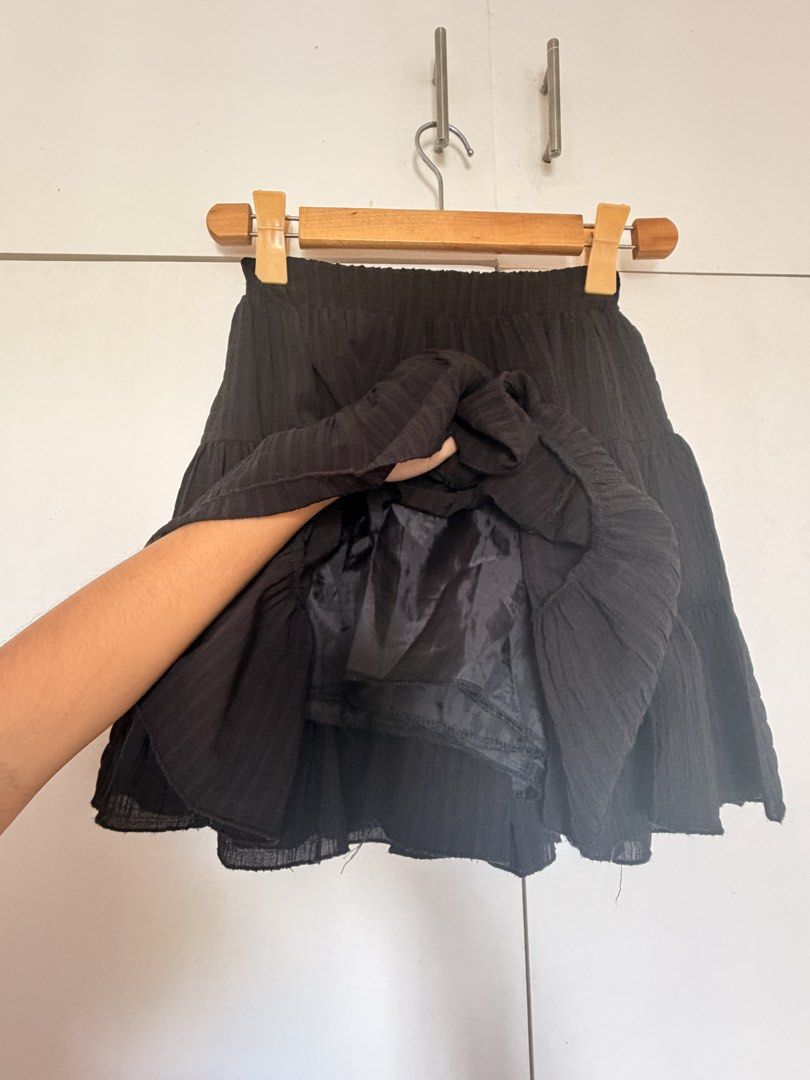 Black tiered ruffle mini skirt with inner shorts (Category: Skirts) located in Marikina City. Submitted by _bananahanaa (Listing ID 1470804701, Image 2). Description: - Color: Classic Black - Style: Multi-layered tiered mini skirt with a flowy, ruffle design - Comfort: Lightweight textured fabric with an easy pull-on elastic waistband - Feature: Comes with built-in inner shorts for worry-free wear - Versatility: Great basic piece to match any cas