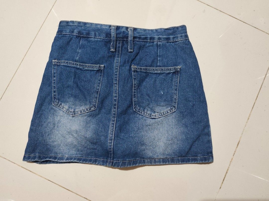 Blue Denim Skort with Built-in Shorts (Category: Skirts) located in Taytay. Submitted by PrelovedCollections (Listing ID 1470744046, Image 3). Description: -S27-28 - Style: Blue denim skort with a trendy light wash faded finish - Comfort: Built-in shorts underneath so you can move with confidence - Details: Decorative front straps with gold-toned hardware and two functional back pockets - Fit: Back zip closure with belt loops - Versatility: Easy 