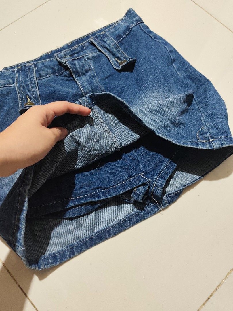 Blue Denim Skort with Built-in Shorts (Category: Skirts) located in Taytay. Submitted by PrelovedCollections (Listing ID 1470744046, Image 2). Description: -S27-28 - Style: Blue denim skort with a trendy light wash faded finish - Comfort: Built-in shorts underneath so you can move with confidence - Details: Decorative front straps with gold-toned hardware and two functional back pockets - Fit: Back zip closure with belt loops - Versatility: Easy 