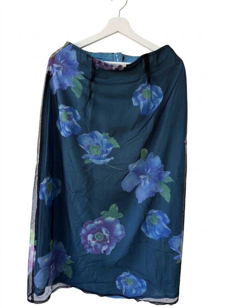 Blue Floral Mesh Maxi Skirt (Category: Skirts) located in Taguig. Submitted by luxeria_ (Listing ID 1470780940, Image 1). Description: - Deep blue maxi skirt with vibrant purple and blue floral print - Elegant sheer black mesh overlay along the edges - Lightweight fabric with a smooth, comfortable lining - Secure and simple back zip closure - Condition: Excellent / Like new - DM for measurements or questions!.