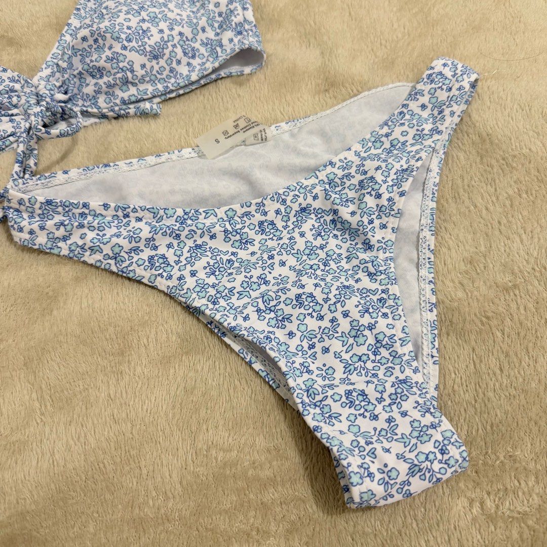 Blue Floral Two-Piece Bikini Set Size S (Category: Bikinis & Swimsuits) located in Manila. Submitted by kbm._. (Listing ID 1470929744, Image 3). Description: - Style: Blue and white floral print two-piece bikini - Condition: Brand new with tags (BNWT), never worn - Size: Small - Features: Adjustable straps, playful front tie detail, and trendy high-cut leg bottoms - Fabric: Soft and stretchy material for a comfortable fit - Mode of transaction: S