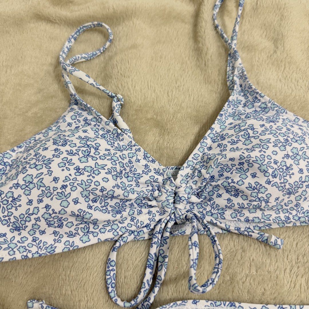 Blue Floral Two-Piece Bikini Set Size S (Category: Bikinis & Swimsuits) located in Manila. Submitted by kbm._. (Listing ID 1470929744, Image 2). Description: - Style: Blue and white floral print two-piece bikini - Condition: Brand new with tags (BNWT), never worn - Size: Small - Features: Adjustable straps, playful front tie detail, and trendy high-cut leg bottoms - Fabric: Soft and stretchy material for a comfortable fit - Mode of transaction: S