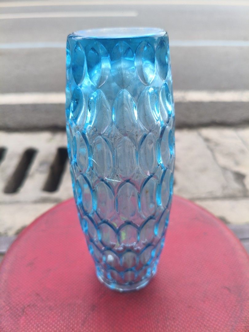 Blue Glass Flower Vase with Textured Pattern (Category: Vases & Decorative Bowls) located in Manila. Submitted by tonio124 (Listing ID 1470786533, Image 3). Description: - Color: Bright blue - Material: Heavy, thick glass - Design: All-over textured scale pattern with a straight cylindrical shape and flared rim - Versatile use: Ideal for fresh flower arrangements or as a standalone tabletop and shelf decor piece.