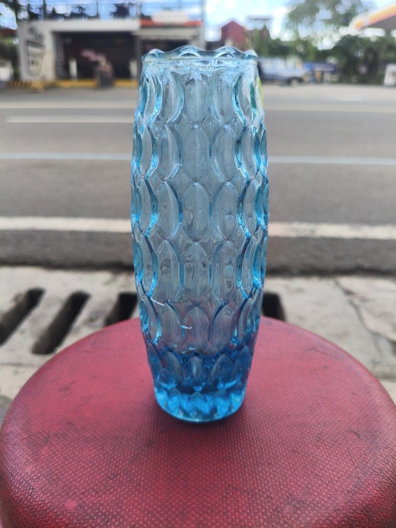 Blue Glass Flower Vase with Textured Pattern (Category: Vases & Decorative Bowls) located in Manila. Submitted by tonio124 (Listing ID 1470786533, Image 1). Description: - Color: Bright blue - Material: Heavy, thick glass - Design: All-over textured scale pattern with a straight cylindrical shape and flared rim - Versatile use: Ideal for fresh flower arrangements or as a standalone tabletop and shelf decor piece.