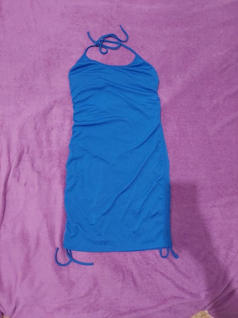 Blue Halter Mini Dress (Category: Dresses) located in Bulacan. Submitted by nicschill18300 (Listing ID 1470866428, Image 2). Description: Brand: SHEIN CURVE Size: 1XL Color: Bright blue / royal blue Style: Sleeveless halter-neck dress Length: Mini dress Design: Slim, body-hugging silhouette Details: Tie-up halter neckline and adjustable-looking side drawstrings near the hem.
