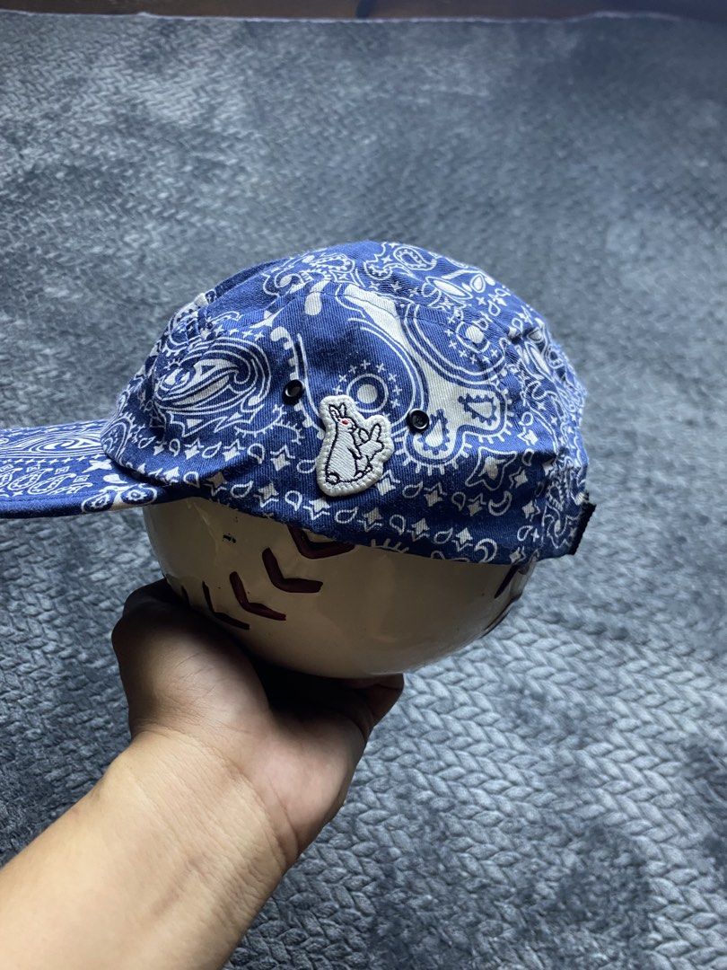 Blue Paisley Print 5-Panel Cap with Rabbit Patch (Category: Caps & Hats) located in Olongapo. Submitted by WAVYT (Listing ID 1470893622, Image 2). Description: - Style: Blue paisley print 5-panel cap - Detail: Small embroidered white rabbit patch with a red accent on the side - Closure: Adjustable black strap with plastic buckle - Comfort: Black inner sweatband lining - Condition: Clean inside and out, ready to wear.