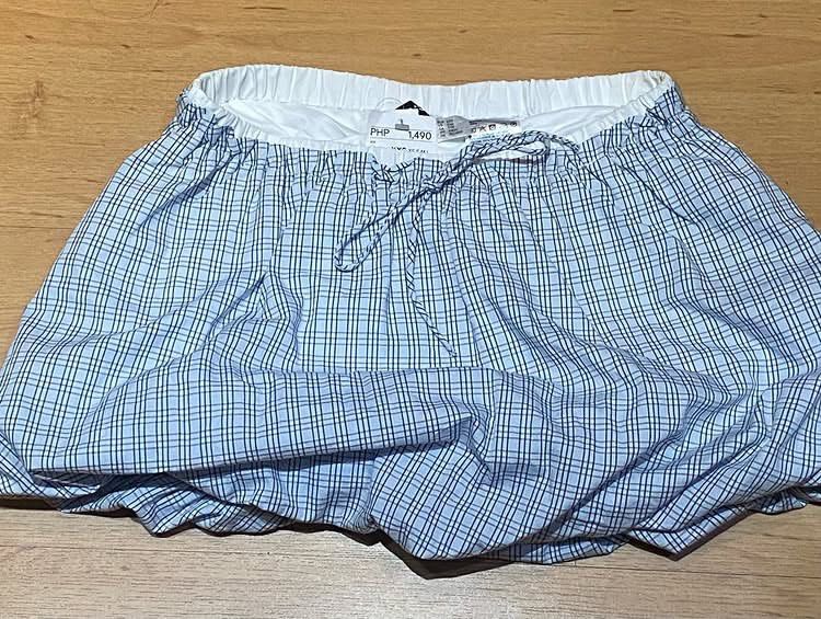 Blue Plaid Bubble Skort Size XXS (Category: Skirts) located in Manila. Submitted by bina_meia (Listing ID 1470830789, Image 2). Description: - Style: Blue and white plaid bubble skirt with built-in shorts for comfort and coverage - Waistband: Elastic with a functional front drawstring tie - Material: Lightweight cotton with full lining - Condition: Brand new with tags (BNWT) - Original Retail Price: 1,490 PHP Hindi lang nagamit and hindi ko na si