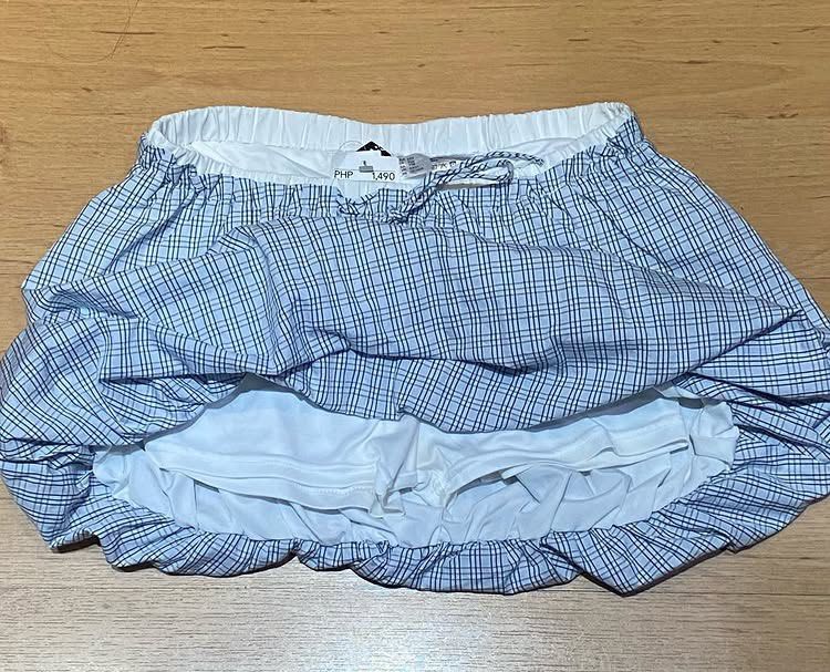 Blue Plaid Bubble Skort Size XXS (Category: Skirts) located in Manila. Submitted by bina_meia (Listing ID 1470830789, Image 3). Description: - Style: Blue and white plaid bubble skirt with built-in shorts for comfort and coverage - Waistband: Elastic with a functional front drawstring tie - Material: Lightweight cotton with full lining - Condition: Brand new with tags (BNWT) - Original Retail Price: 1,490 PHP Hindi lang nagamit and hindi ko na si