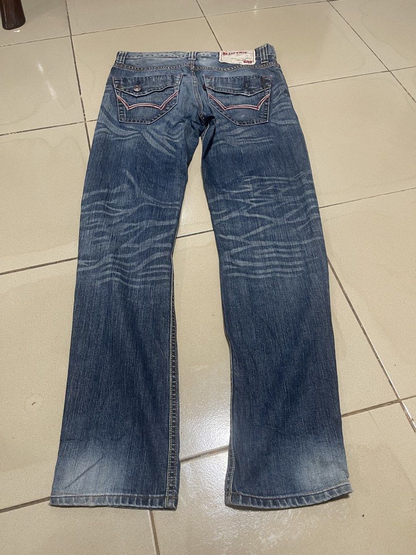 Blue Trip 503 Denim Jeans (Category: Jeans) located in Davao. Submitted by rcgulanes.moon (Listing ID 1470880916, Image 2). Description: - Brand/Model: Blue Trip 503 denim jeans - Design: Whiskering effects on front and back legs - Pockets: Flap back pockets with red stitching and button closure - Details: Classic canvas patch on back waistband and distressed hem edges - Material: Sturdy denim fabric throughout.