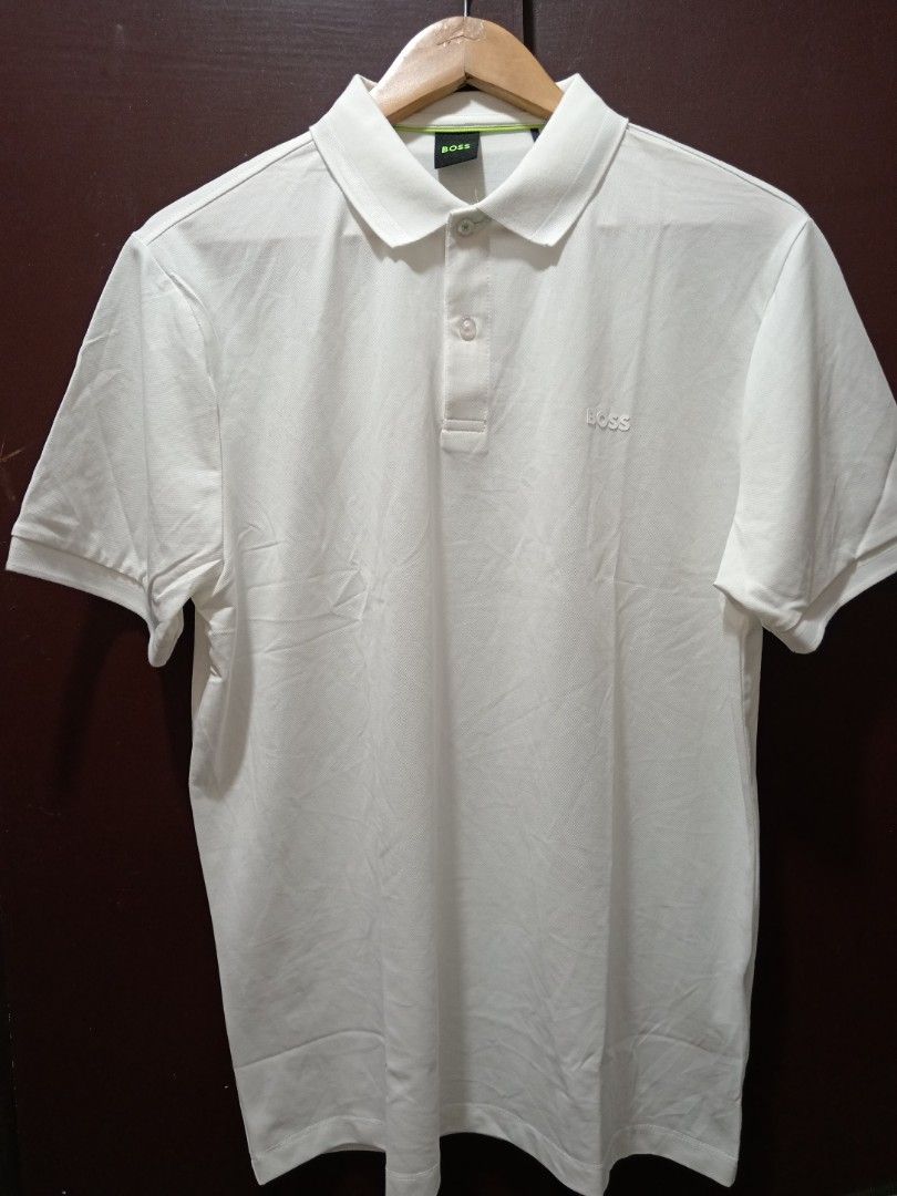 BOSS White Polo Shirt Size XL (Category: Tshirts & Polo Shirts ) located in Baguio. Submitted by solo_ukay (Listing ID 1470807577, Image 1). Description: - Brand: BOSS - Color: Clean White - Size: XL - Material: 95% Cotton, 5% Spandex for comfortable stretch - Design: Short sleeves, classic collar with button placket, subtle embroidered logo on the chest - Condition: Great casual staple.