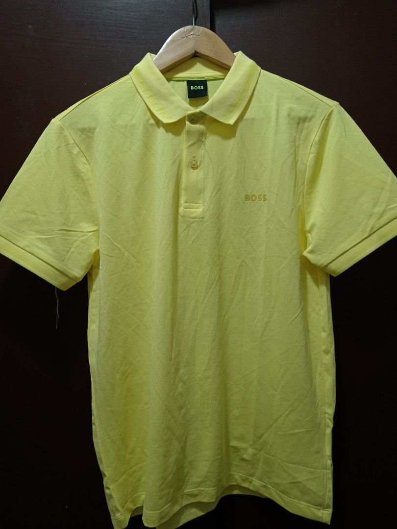 BOSS Yellow Polo Shirt Size M (Category: Tshirts & Polo Shirts ) located in Baguio. Submitted by solo_ukay (Listing ID 1470807483, Image 1). Description: - Brand: BOSS - Color: Bright Yellow - Size: Medium (M) - Material: 95% Cotton, 5% Spandex (stretchable and comfortable) - Design: Classic collar with two buttons and embroidered BOSS logo on the chest - Details: Black inner neck tag with green lettering - Condition: Excellent, ready to wear.