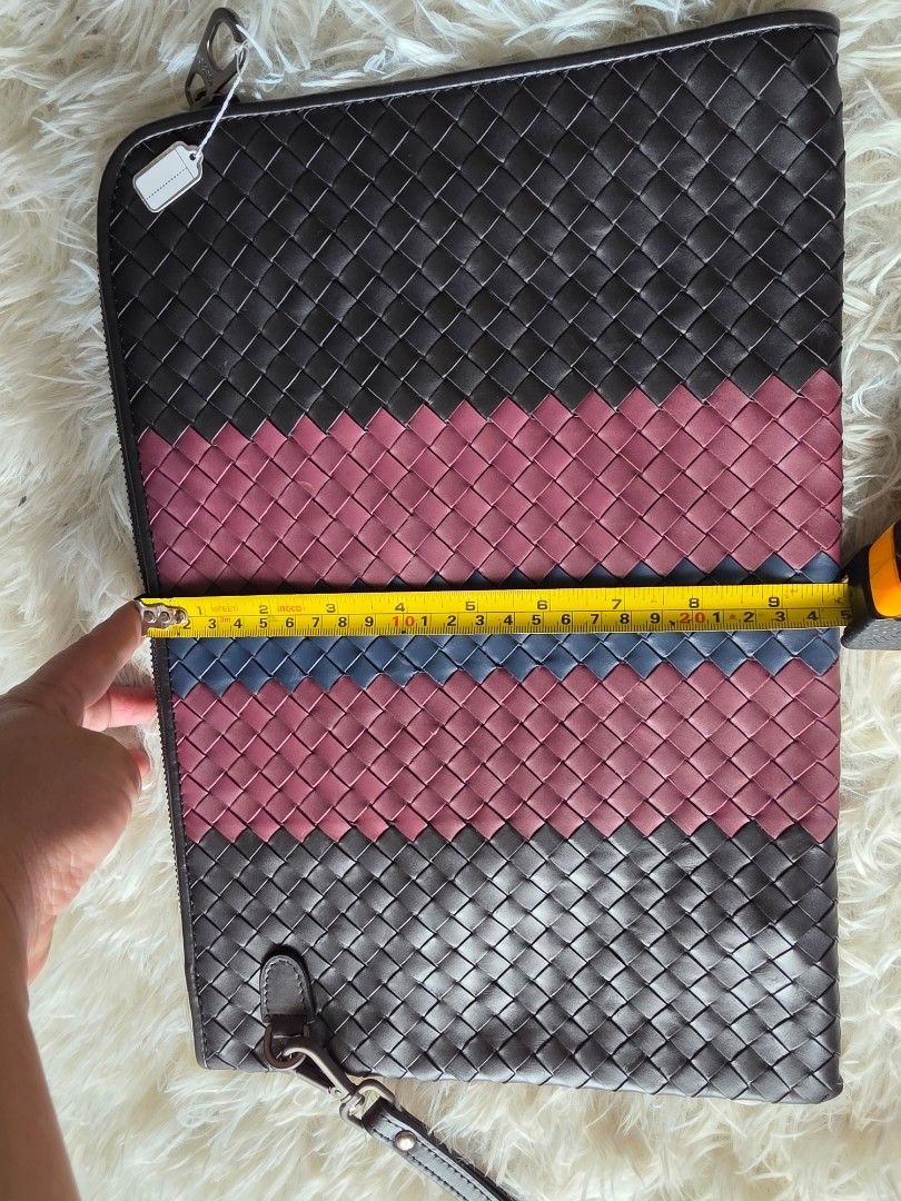 Bottega Veneta Intrecciato Leather Document Case Clutch Multi (Category: Clutches) located in Lemery. Submitted by venus23 (Listing ID 1470746458, Image 3). Description: - Bottega Veneta clutch featuring signature intrecciato woven leather - Eye-catching vertical stripe design in black, burgundy, and blue - Secure zip-top closure with a lined interior, including a zippered pocket and slip pocket - Includes a practical detachable wrist strap for v