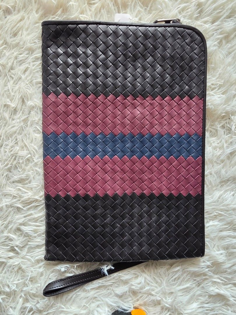Bottega Veneta Intrecciato Leather Document Case Clutch Multi (Category: Clutches) located in Lemery. Submitted by venus23 (Listing ID 1470746458, Image 1). Description: - Bottega Veneta clutch featuring signature intrecciato woven leather - Eye-catching vertical stripe design in black, burgundy, and blue - Secure zip-top closure with a lined interior, including a zippered pocket and slip pocket - Includes a practical detachable wrist strap for v