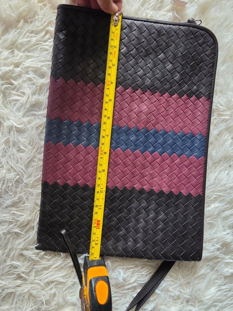 Bottega Veneta Intrecciato Leather Document Case Clutch Multi (Category: Clutches) located in Lemery. Submitted by venus23 (Listing ID 1470746458, Image 2). Description: - Bottega Veneta clutch featuring signature intrecciato woven leather - Eye-catching vertical stripe design in black, burgundy, and blue - Secure zip-top closure with a lined interior, including a zippered pocket and slip pocket - Includes a practical detachable wrist strap for v