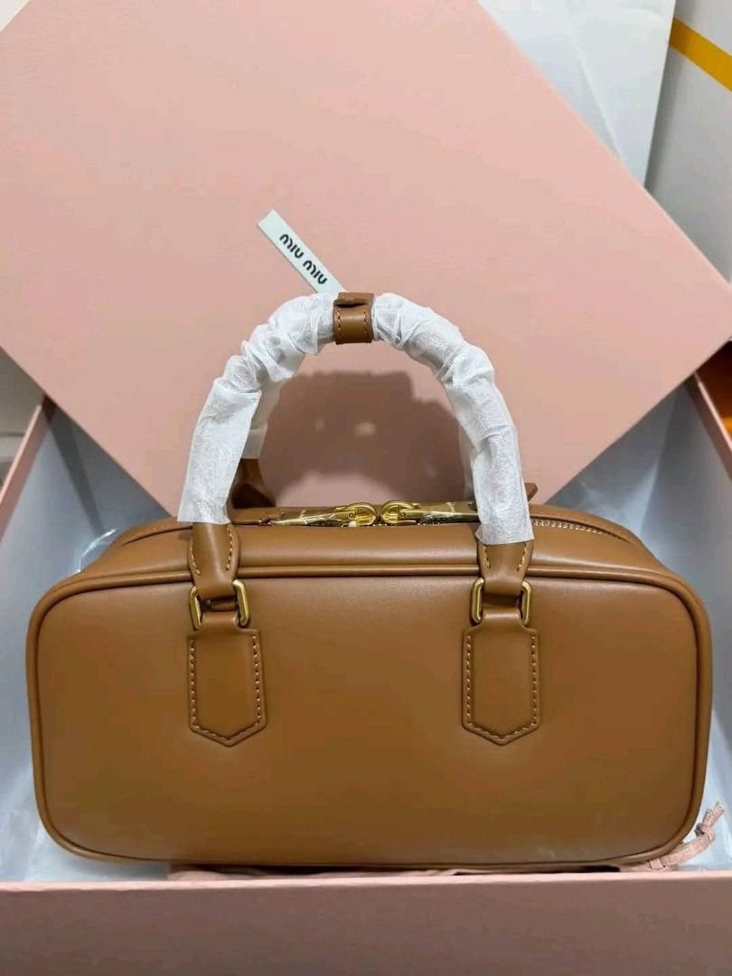 Bowling bag‼️ (Category: Shoulder Bags) located in Manila. Submitted by bagsallshop (Listing ID 1470833396, Image 3). Description: ✅ Style: Tan Leather Bowling Bag ✅ Condition: Brand new with protective plastic on handles and metal feet ✅ Hardware: Gold-tone ✅ Interior: Fabric-lined with a secure zip pocket ✅ Inclusions: dust bag, paperbag .