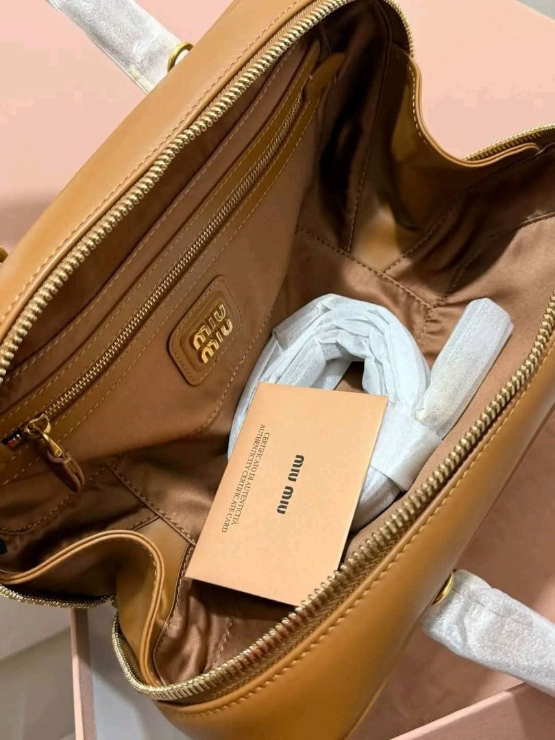 Bowling bag‼️ (Category: Shoulder Bags) located in Manila. Submitted by bagsallshop (Listing ID 1470833396, Image 2). Description: ✅ Style: Tan Leather Bowling Bag ✅ Condition: Brand new with protective plastic on handles and metal feet ✅ Hardware: Gold-tone ✅ Interior: Fabric-lined with a secure zip pocket ✅ Inclusions: dust bag, paperbag .